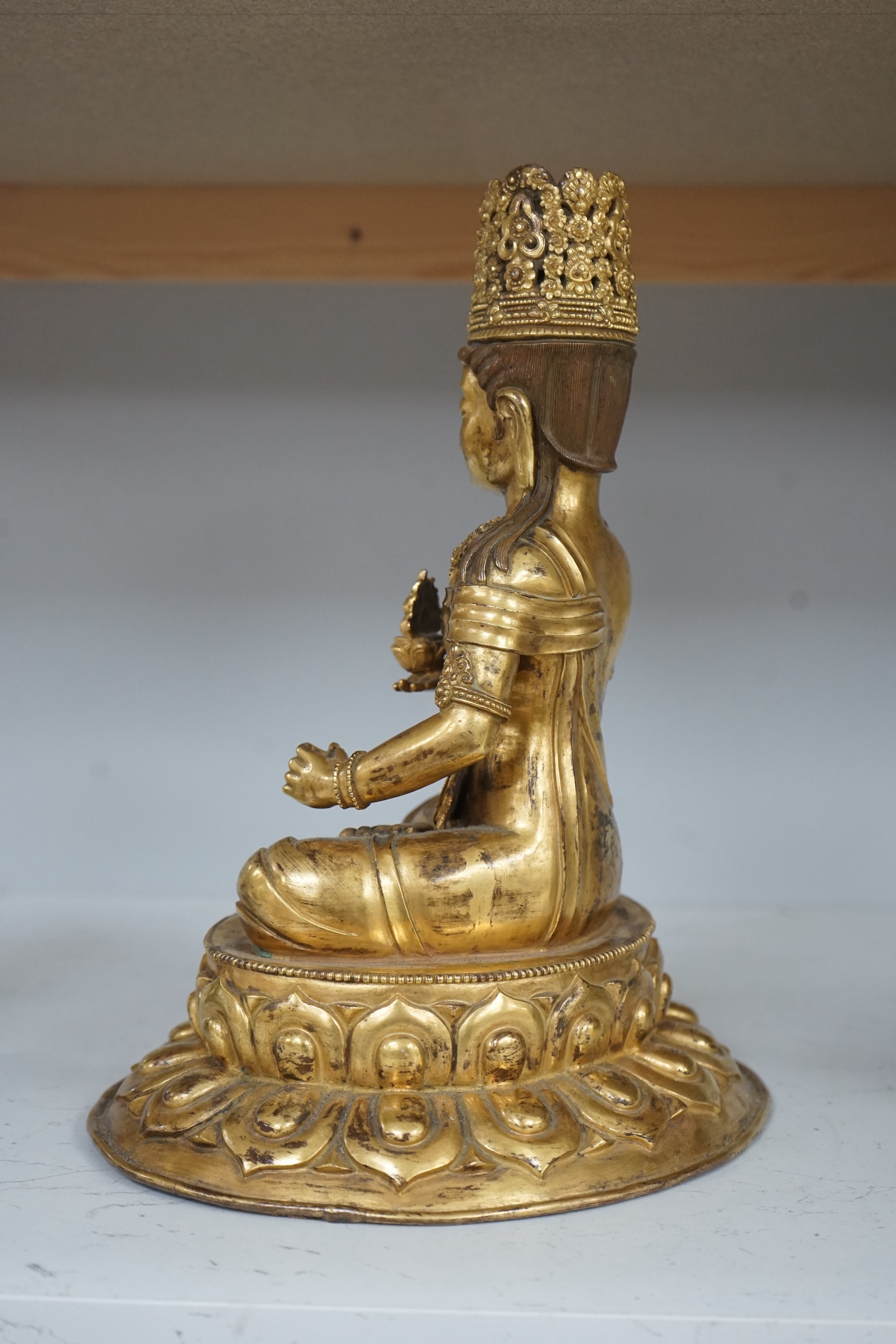 Tibetan School, 20th century gilt bronze figure of a seated deity, 31cm high. Condition - good